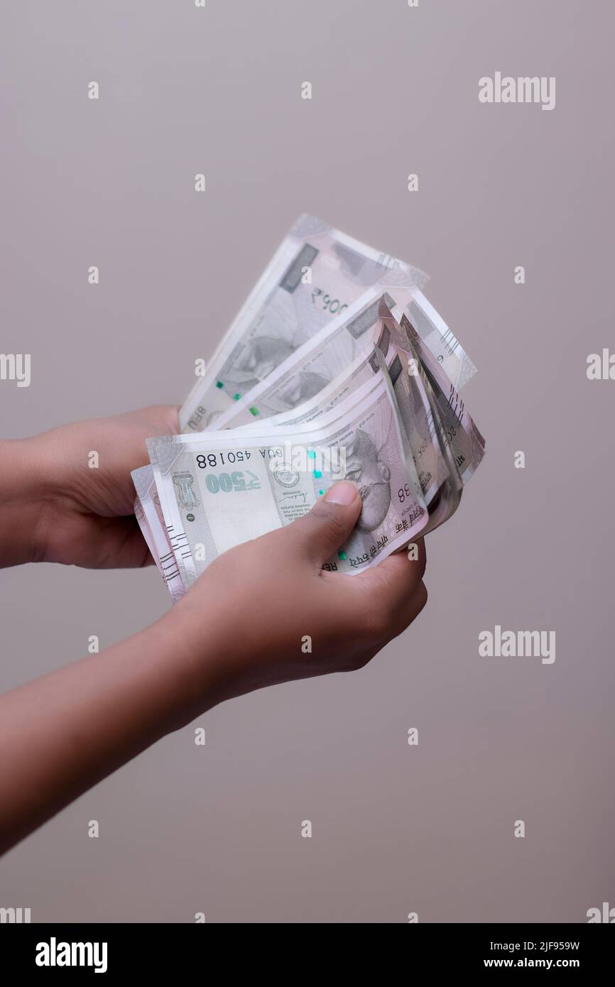 selective focus counting Indian five hundred rupees currency notes. Stock Photo