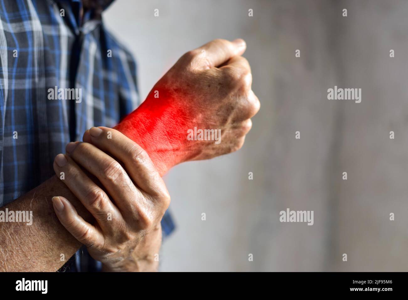 Inflammation in the wrist joint of Asian old man. Concept of joint pain or osteoarthritis Stock
