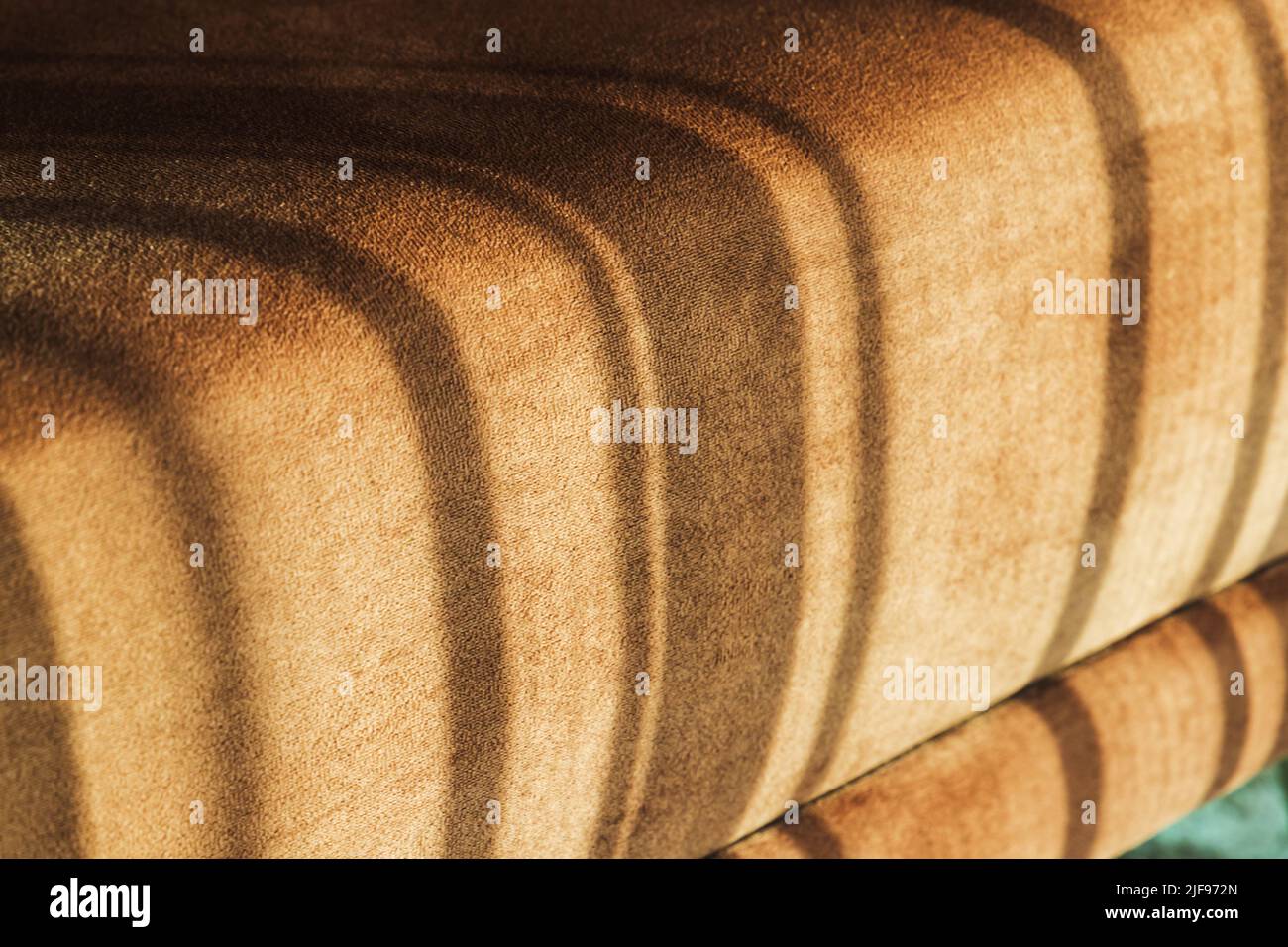 Sofa cushion with sunlight pattern on it, abstract cozy interior fragment Stock Photo
