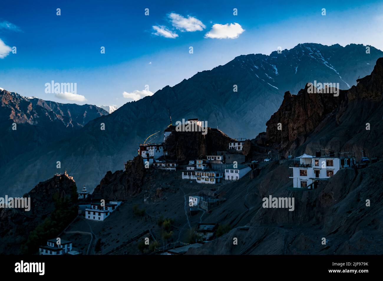 A breathtaking view ofwhite houses on the hill on blue cloudy sky background Stock Photo