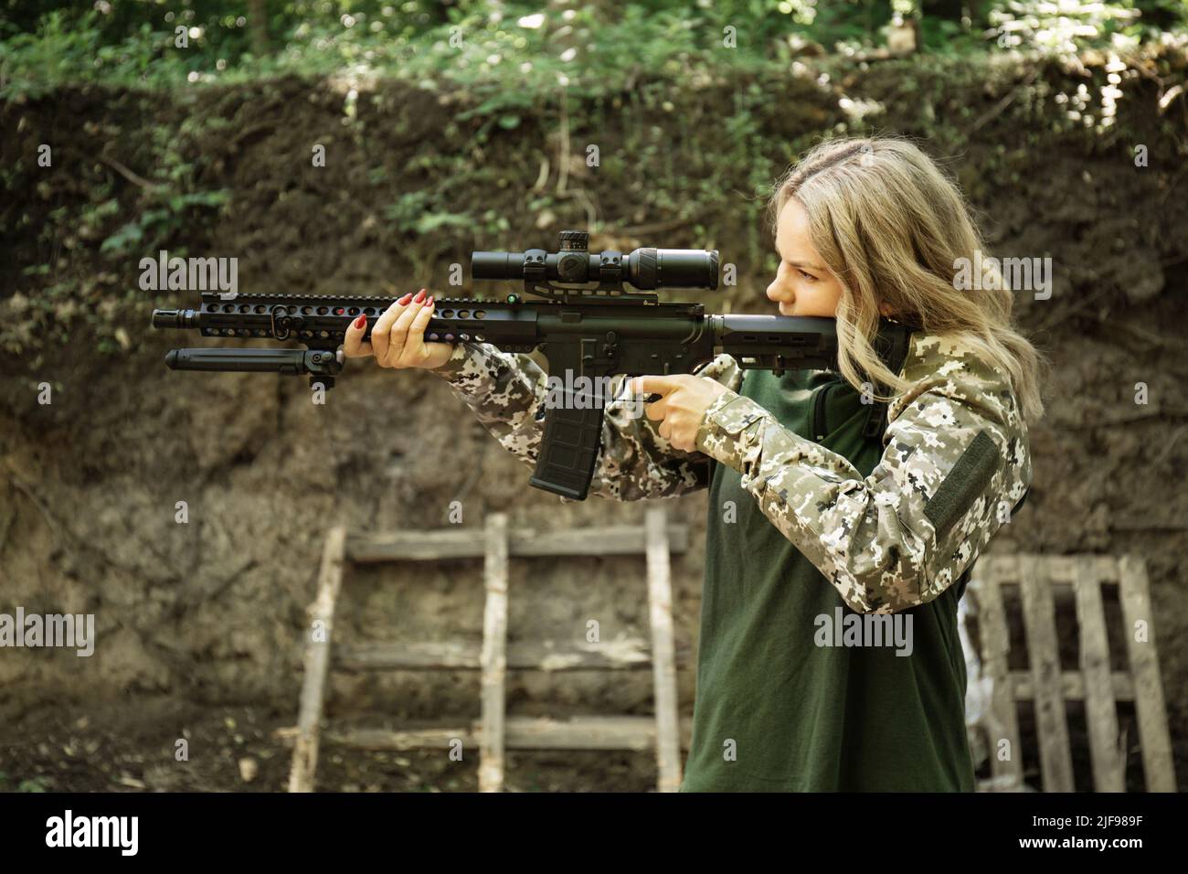 Portrait of a Ukrainian military woman with a assault rifle Ar-15 in ...