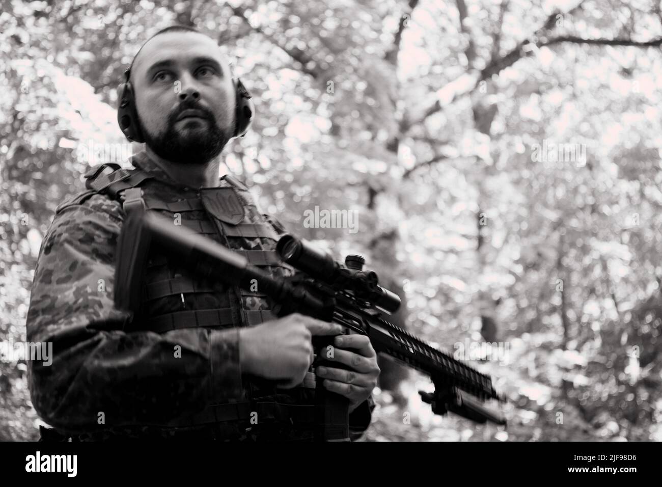 Portrait of a young soldier with a machine gun Stock Photo - Alamy