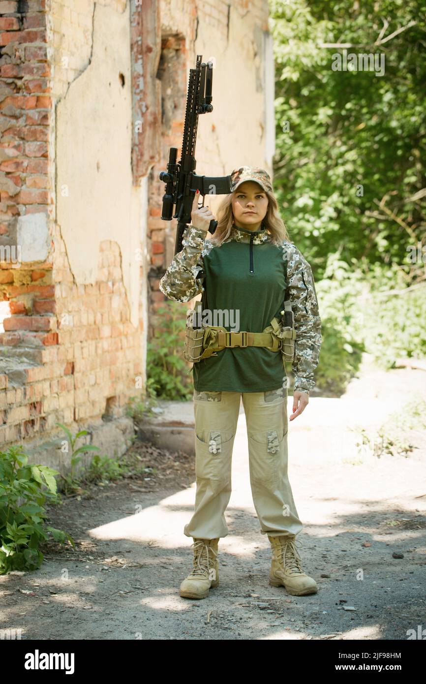 Portrait of a Ukrainian military woman with a assault rifle Ar-15 in ...
