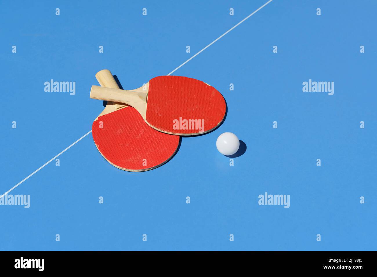 Ping pong tennis table background. Tennis rackets and a ball on a blue sports table. High quality photo Stock Photo