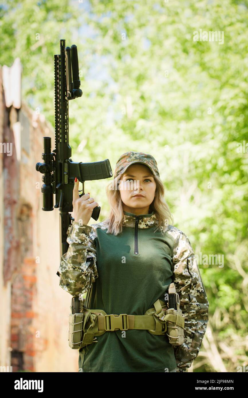 Portrait of a Ukrainian military woman with a assault rifle Ar-15 in ...