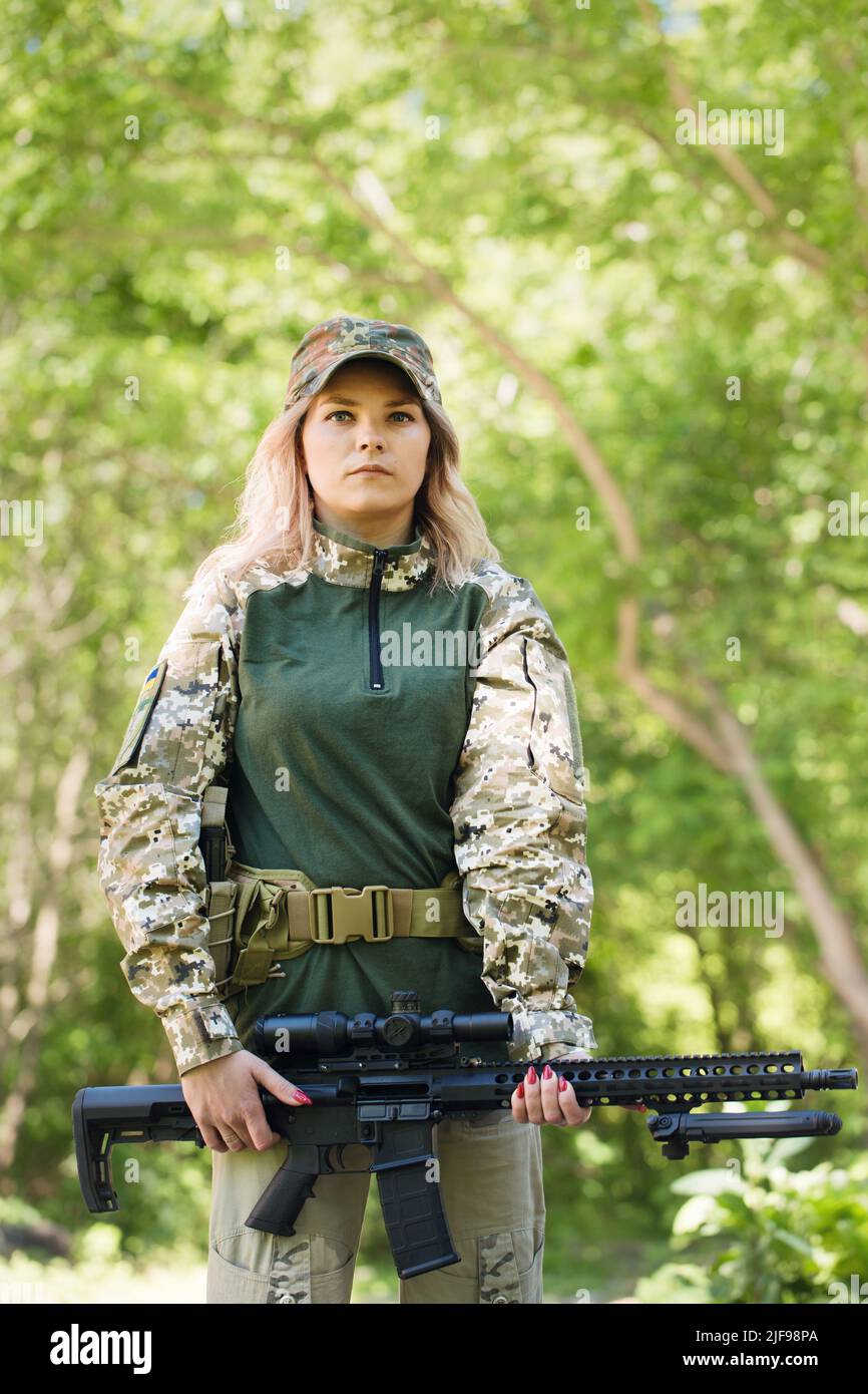 Portrait of a Ukrainian military woman with a assault rifle Ar-15 in ...