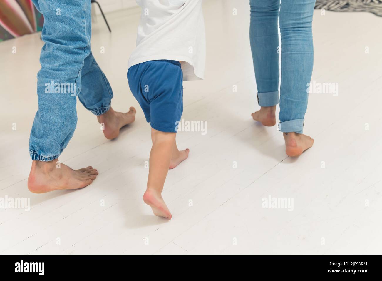 little boy walking with his parents in the kitchen family concept. High quality photo Stock Photo