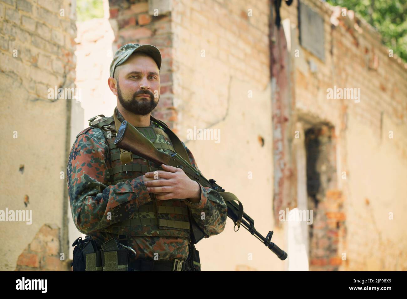 Portrait of a Ukrainian military man with a Kalashnikov assault rifle ...
