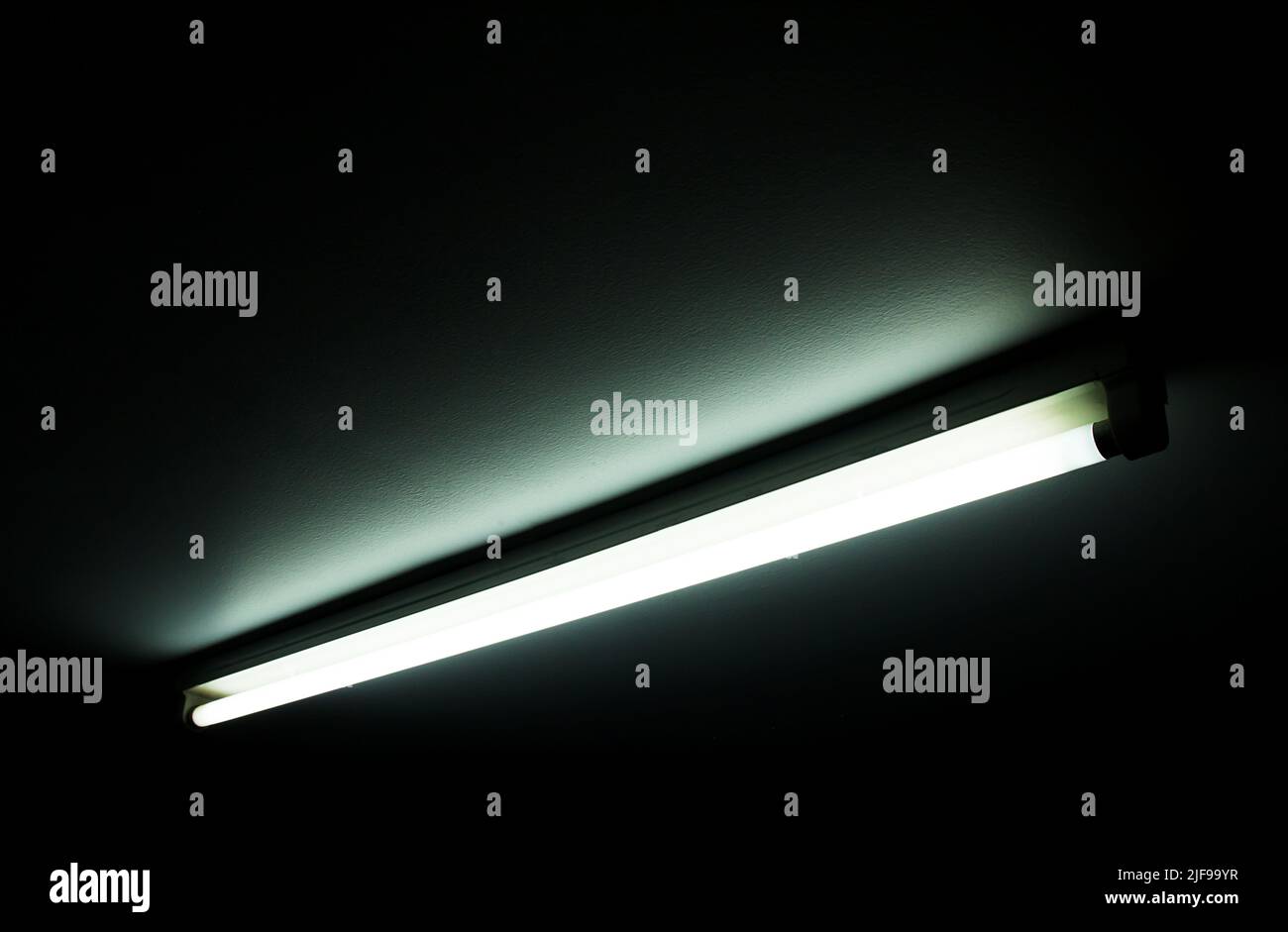 Detail of a fluorescent light tube on a wall. fluorescent light tube with copy space for any