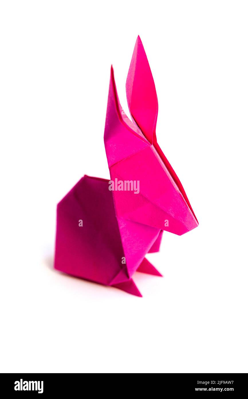 Pink paper rabbit origami isolated on a blank white background. Stock Photo