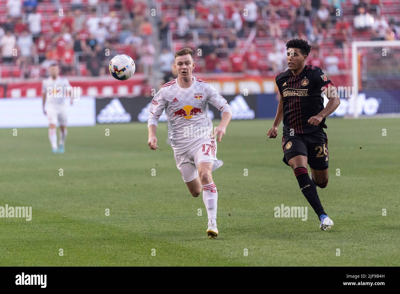 Harrison, United States. 30th June, 2022. Cameron Harper (17) of Red Bulls and Caleb Wiley (26) of Atlanta United chase the ball during MLS regular season game at Red Bull Arena. Red Bulls won 2 - 1. (Photo by Lev Radin/Pacific Press) Credit: Pacific Press Media Production Corp./Alamy Live News Stock Photo
