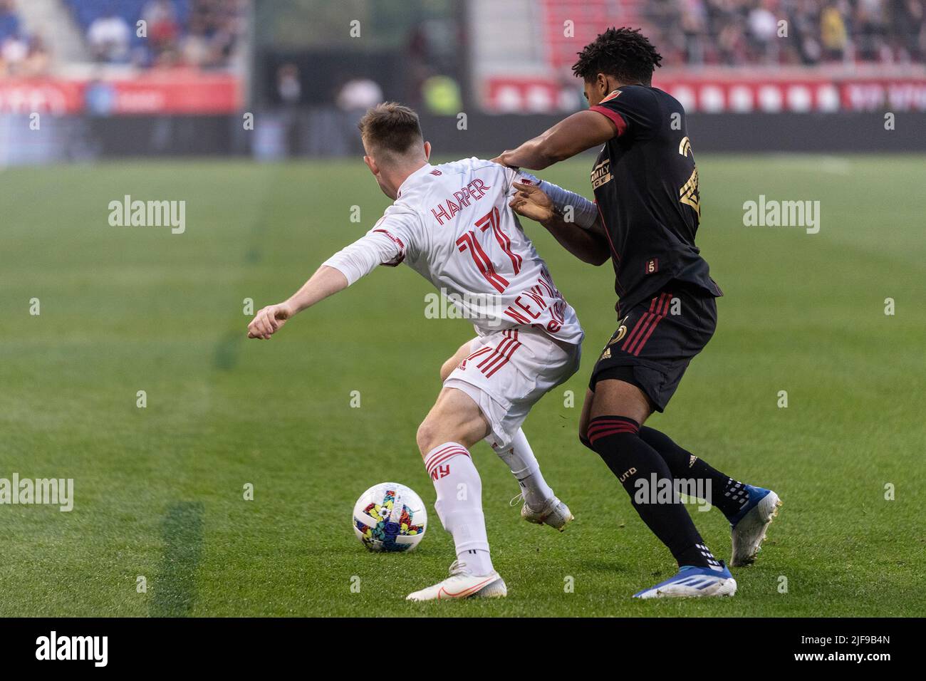 Harrison, United States. 30th June, 2022. Cameron Harper (17) of Red Bulls and Caleb Wiley (26) of Atlanta United fight for ball during MLS regular season game at Red Bull Arena. Red Bulls won 2 - 1. (Photo by Lev Radin/Pacific Press) Credit: Pacific Press Media Production Corp./Alamy Live News Stock Photo