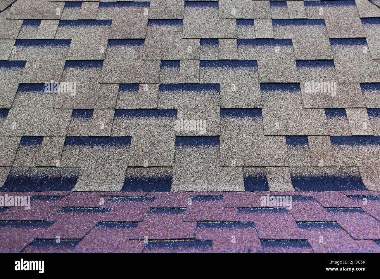 Asphalt roofing in a symmetrical pattern. Composite shingle. Repeating