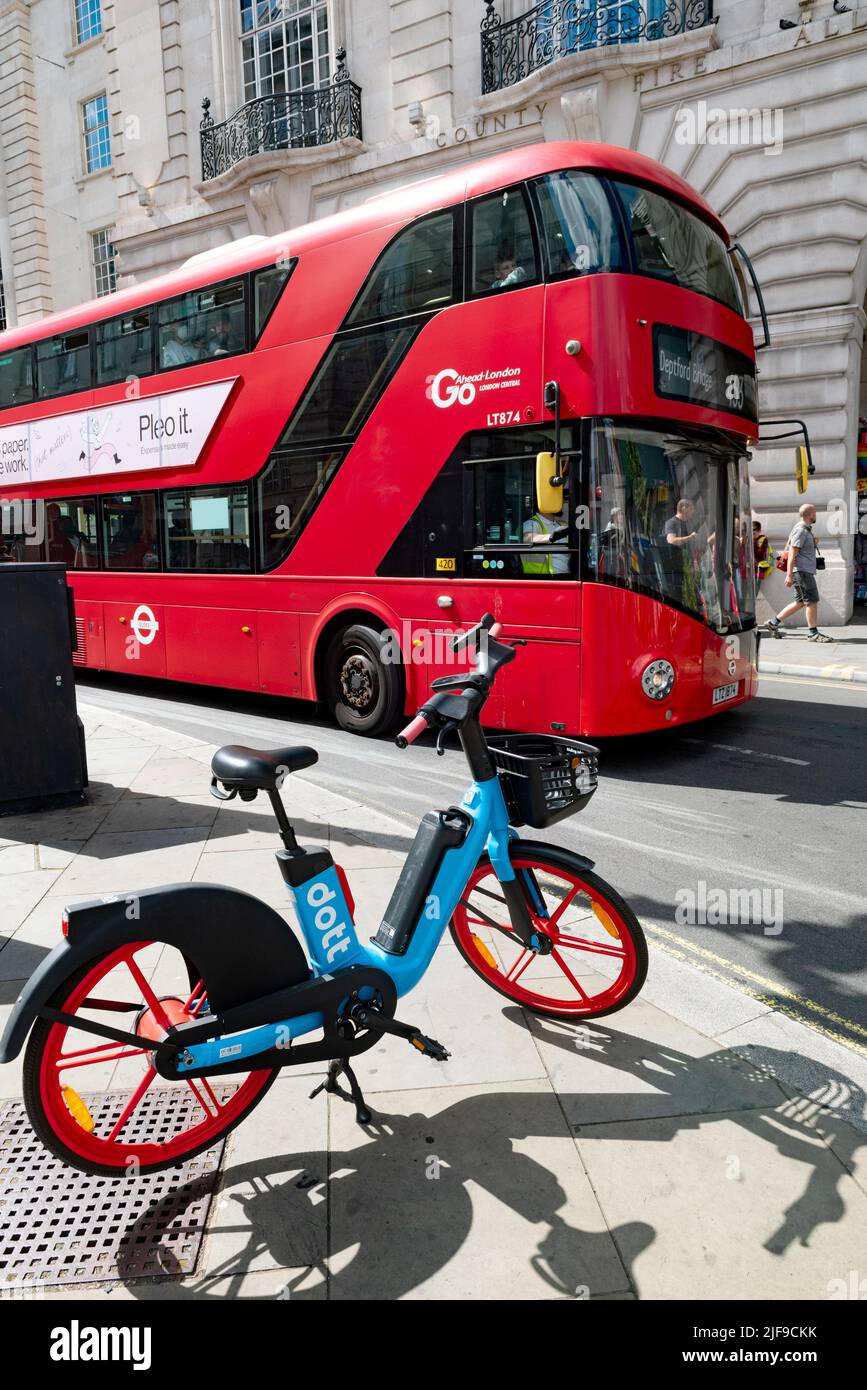 London, United Kingdom, June 28th 2022 Dott Electric E bike available to hire in the West End of London a double decker London Bus, UK Stock Photo