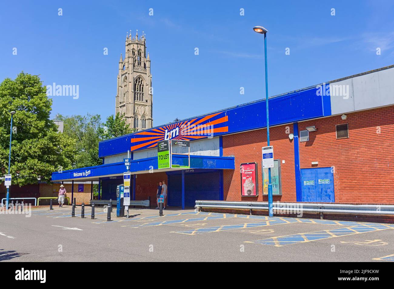 The closed down B & M store with the stump tower in the background on a sunny day Stock Photo