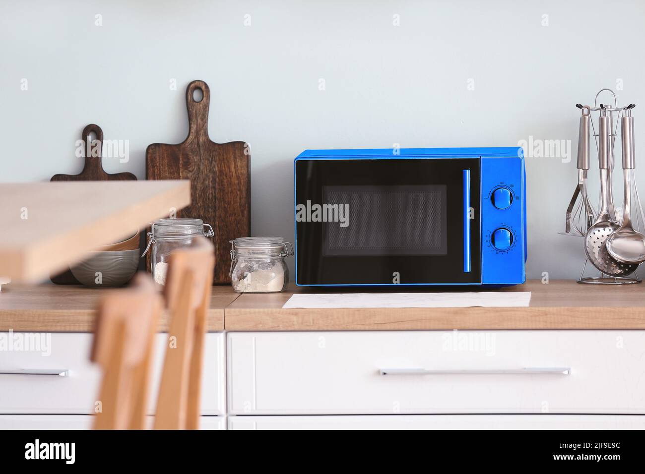 Modern microwave oven on table in kitchen Stock Photo Alamy