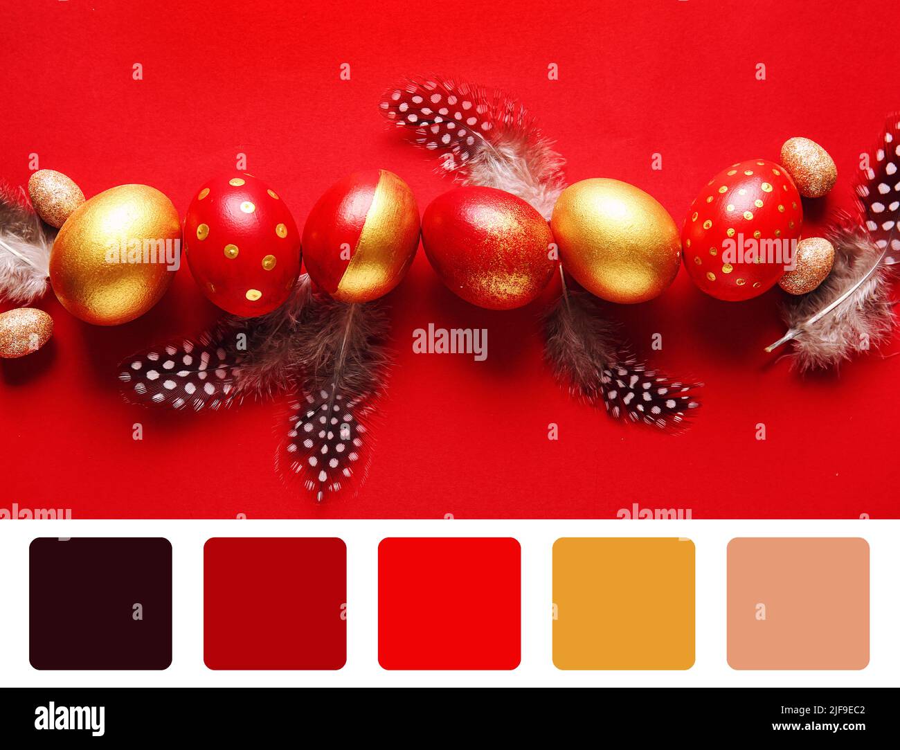 Stylish Easter eggs and feathers on red background. Different color patterns Stock Photo