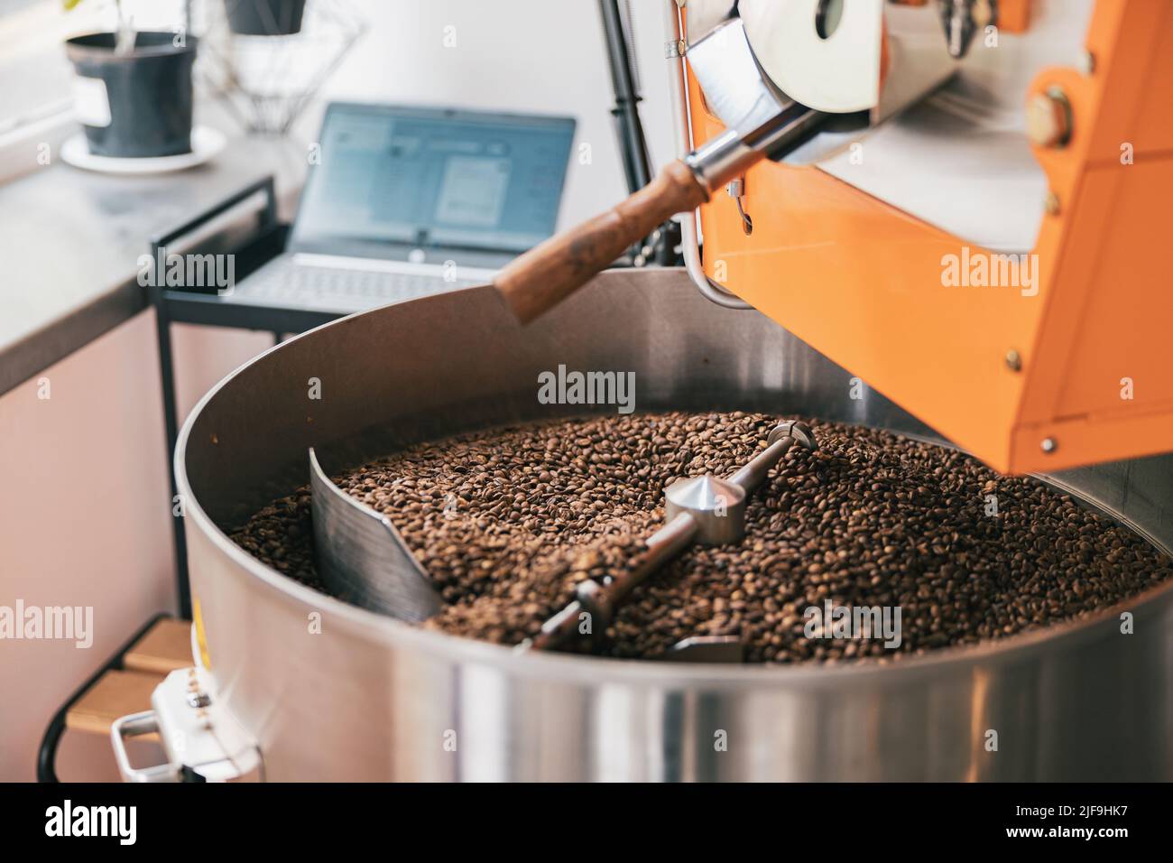 Close up of coffee roasting machine with coffee beans in small coffee ...