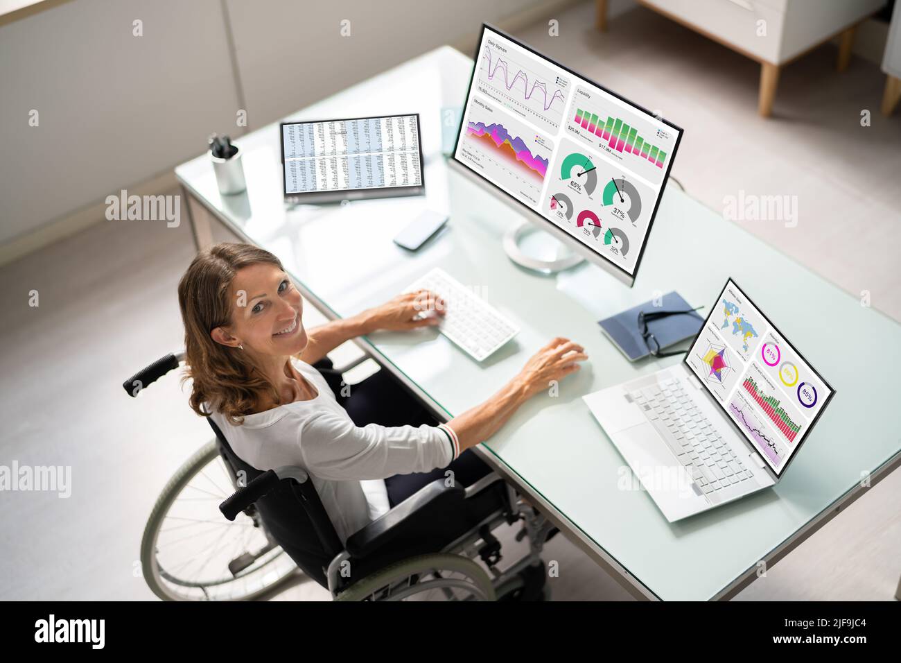 Portrait Of A Happy Businesswoman With A Graph On Computer Screen Stock Photo