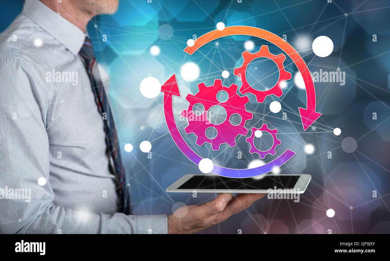 Automation concept above a tablet held by a man Stock Photo