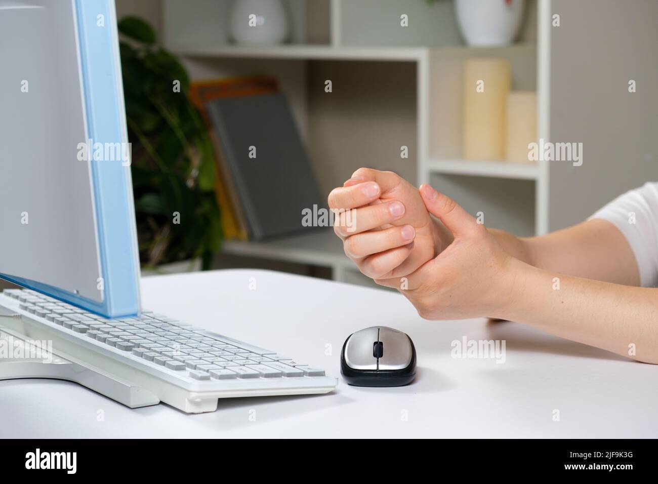 Hands of a person with carpal tunnel syndrome, a computer and a mouse Stock Photo Alamy