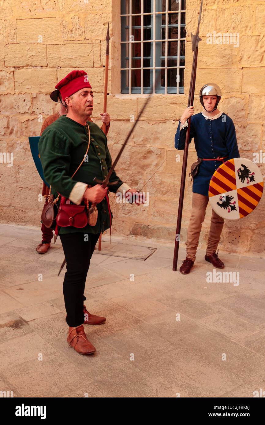 A nobleman Francesco Gatto demonstrating his weapons to an audience in a reenactment of 15th century life at Mdina, Malta, Mediterranean A tour guide, Stock Photo