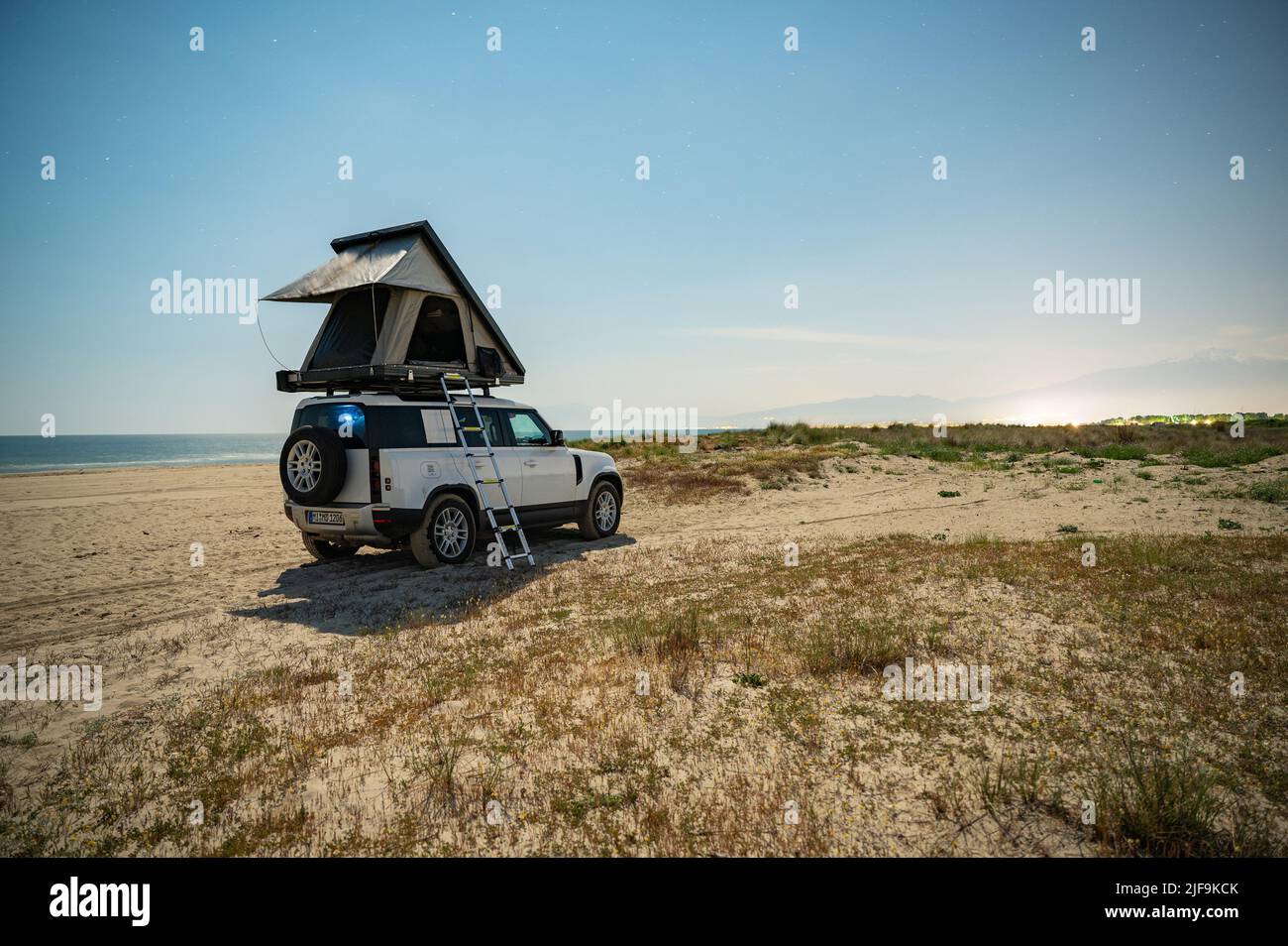 Camping on the beach with 4x4 all terrain vehicle and roof tent ...
