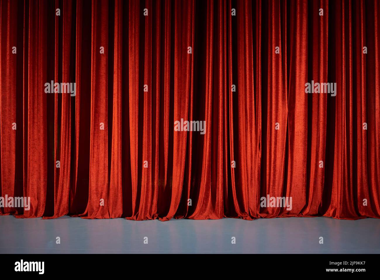 Closed red curtains on stage in theater. Stock Photo