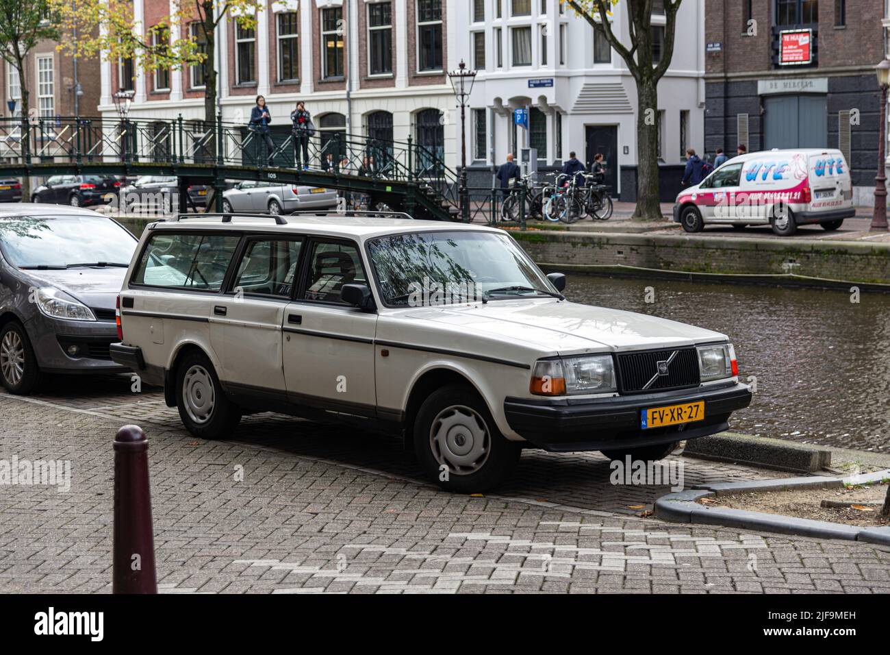 Old and classic blue car parked in the street. Volvo 240 Stock Photo