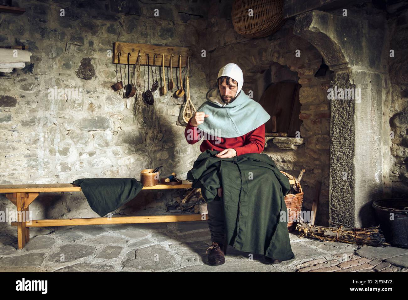 customs-and-traditions-in-13th-century-italy-dress-sewing-stock-photo