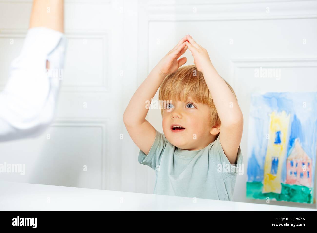 Cute boy in development finger game class with therapist Stock Photo