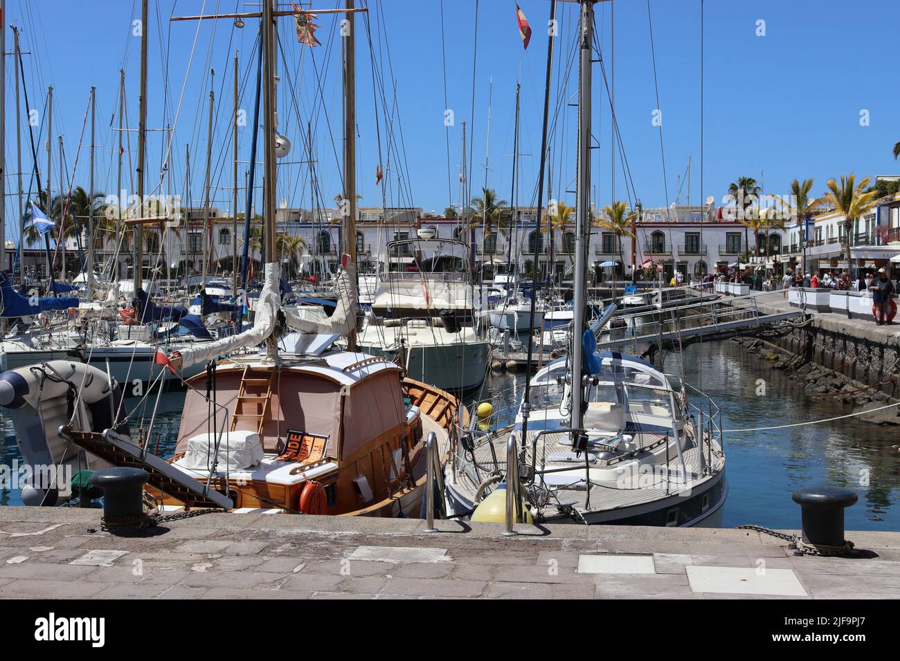 Yachts and cabin cruisers compete for moorings at the marina in  Playa de Mogan, Gran Canaria Stock Photo