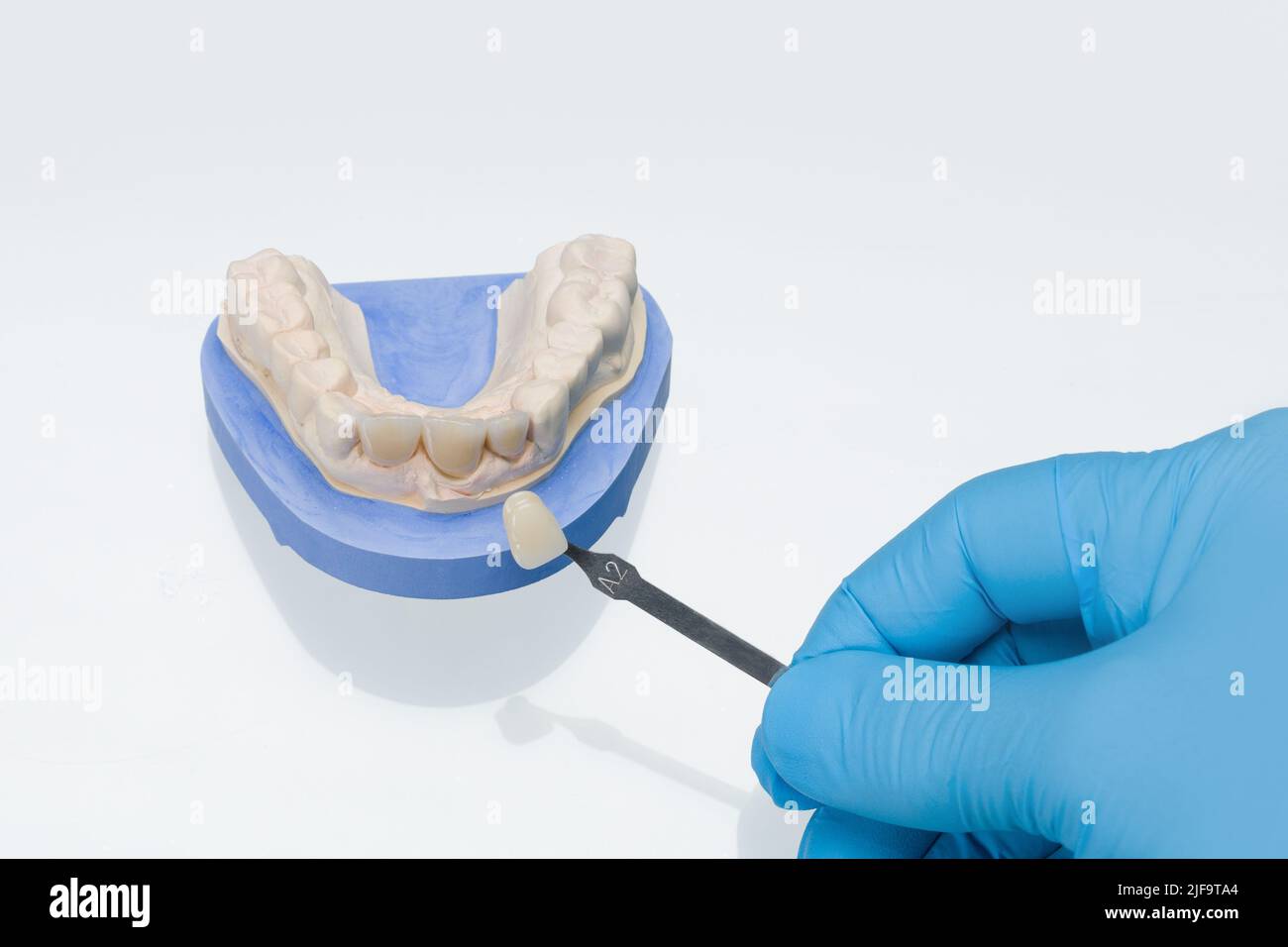 Using a shade guide for correct shading of artificial denture parts in dental laboratory Stock Photo