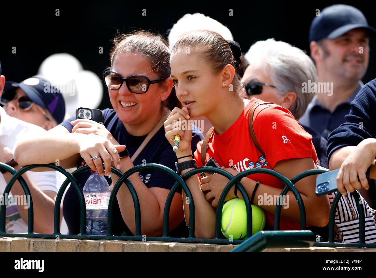 Spectators watch on as players warm up on the practice courts during day five of the 2022
