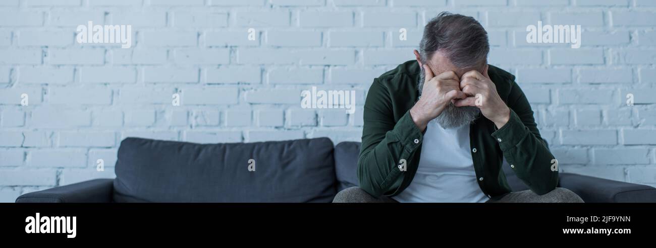 Sad senior man sitting on couch hi-res stock photography and images - Alamy
