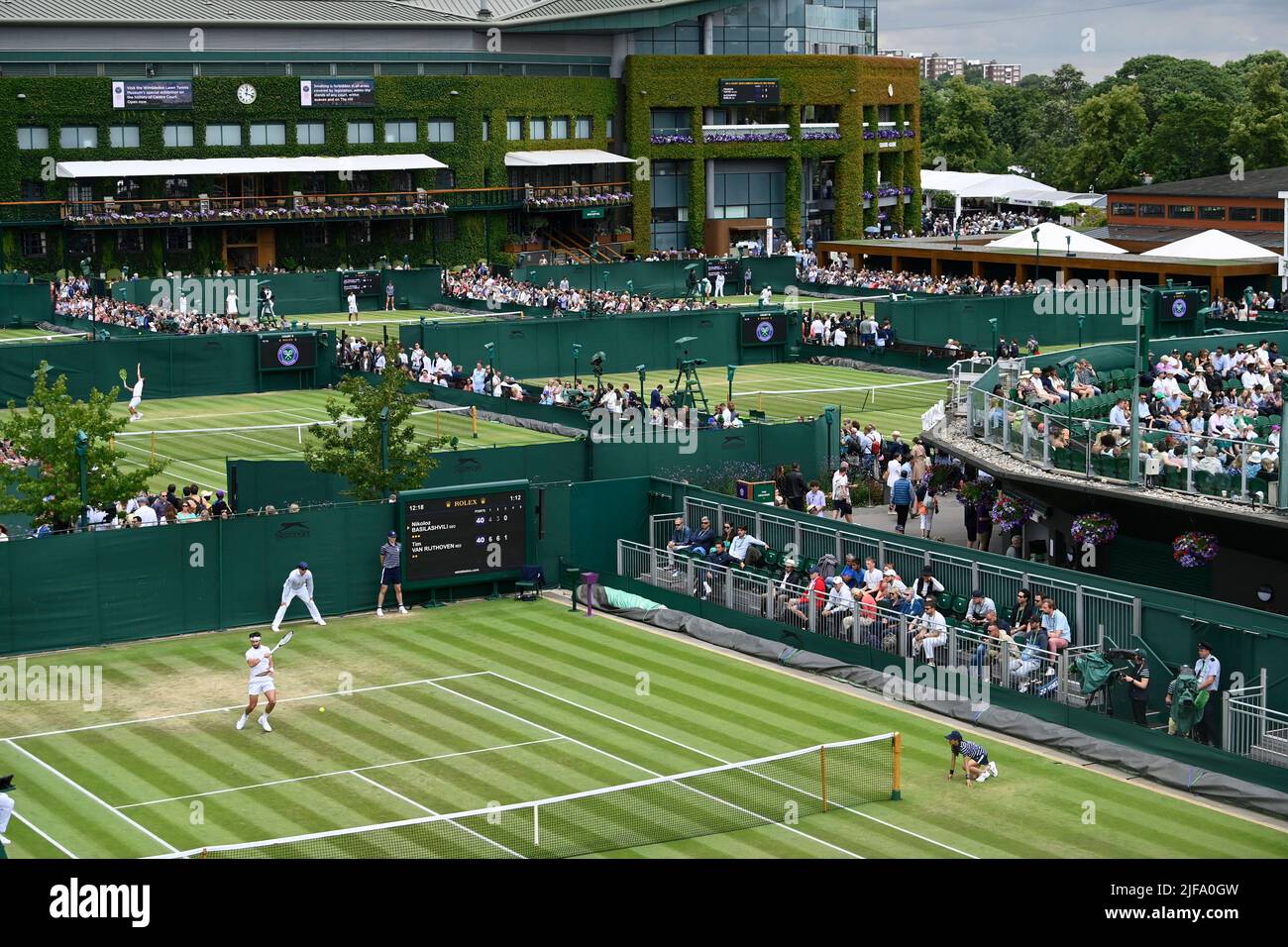 Tennis - Wimbledon - All England Lawn Tennis and Croquet Club, London, Britain - July 1, 2022 General view of the outer courts and Georgia's Nikoloz Basilashvili in action during his third round match against against Netherlands' Tim van Rijthoven REUTERS/Toby Melville Stock Photo