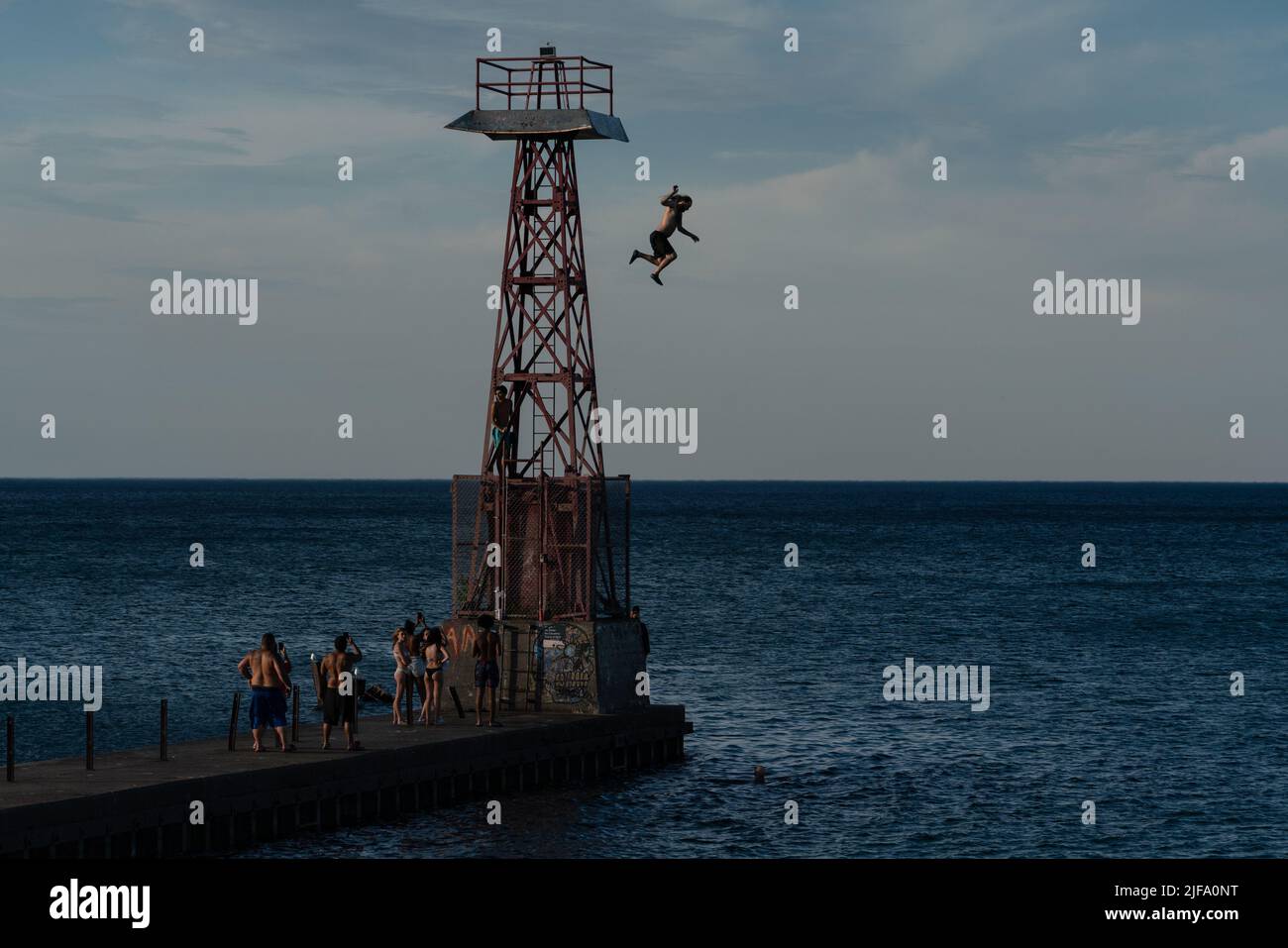Chicago, USA. 30th June, 2022. People jump into Lake Michigan to cool off on a 90degree day in