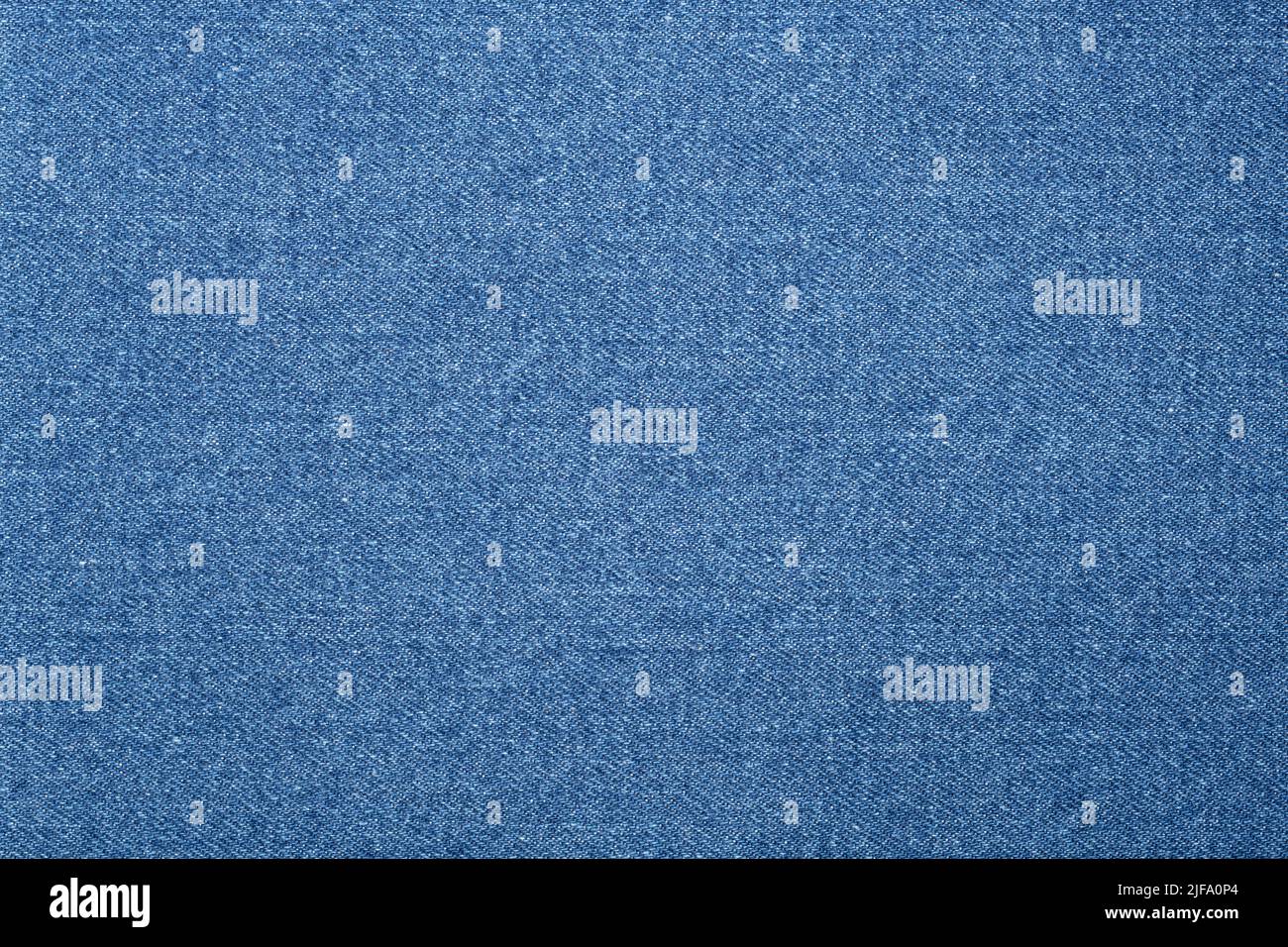 Textured fabric background. A jean or denim texture in light blue. Stock Photo
