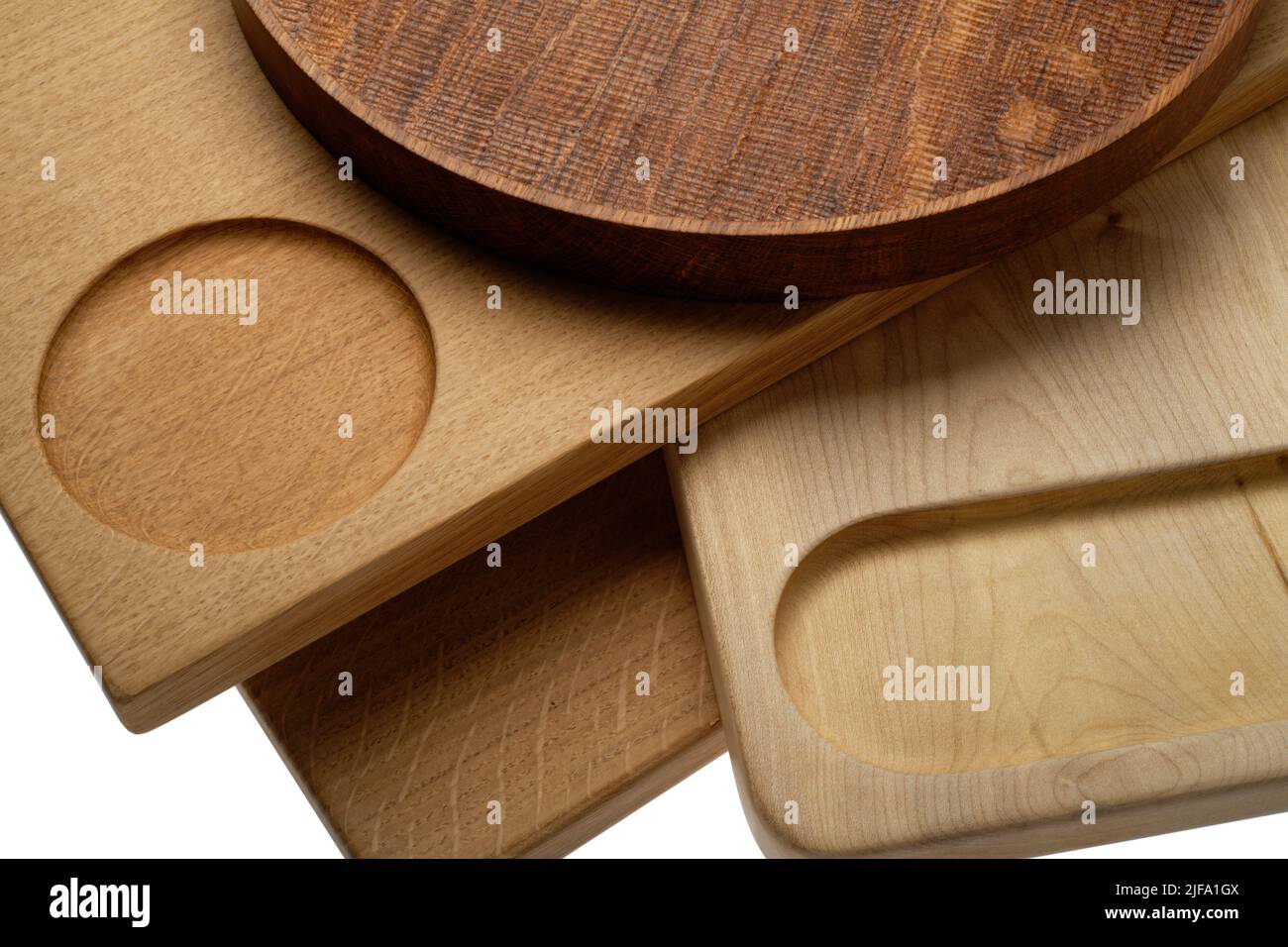 A group of wooden chopping boards and a round tray found in the modern kitchen. Food prep boards. Stock Photo