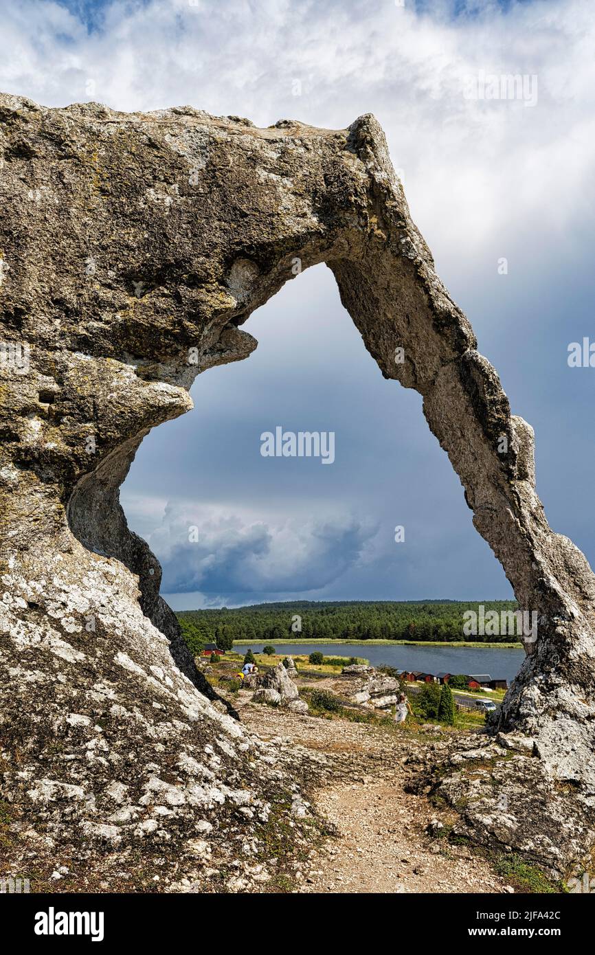 Hiking trail through rock gate Lergravsporten, limestone formation in Lergravsviken nature reserve, Gotland Island, Sweden Stock Photo