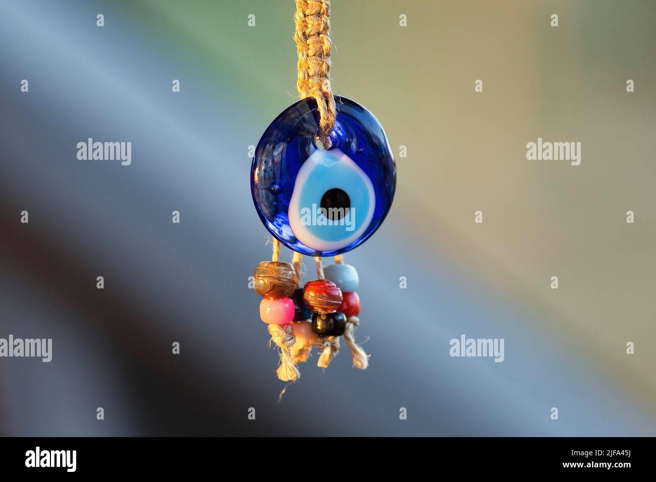 Eye of Fatima, Nazar, Boncuk, blue glass bead, amulet against the evil eye hangs on cord, decoration Stock Photo