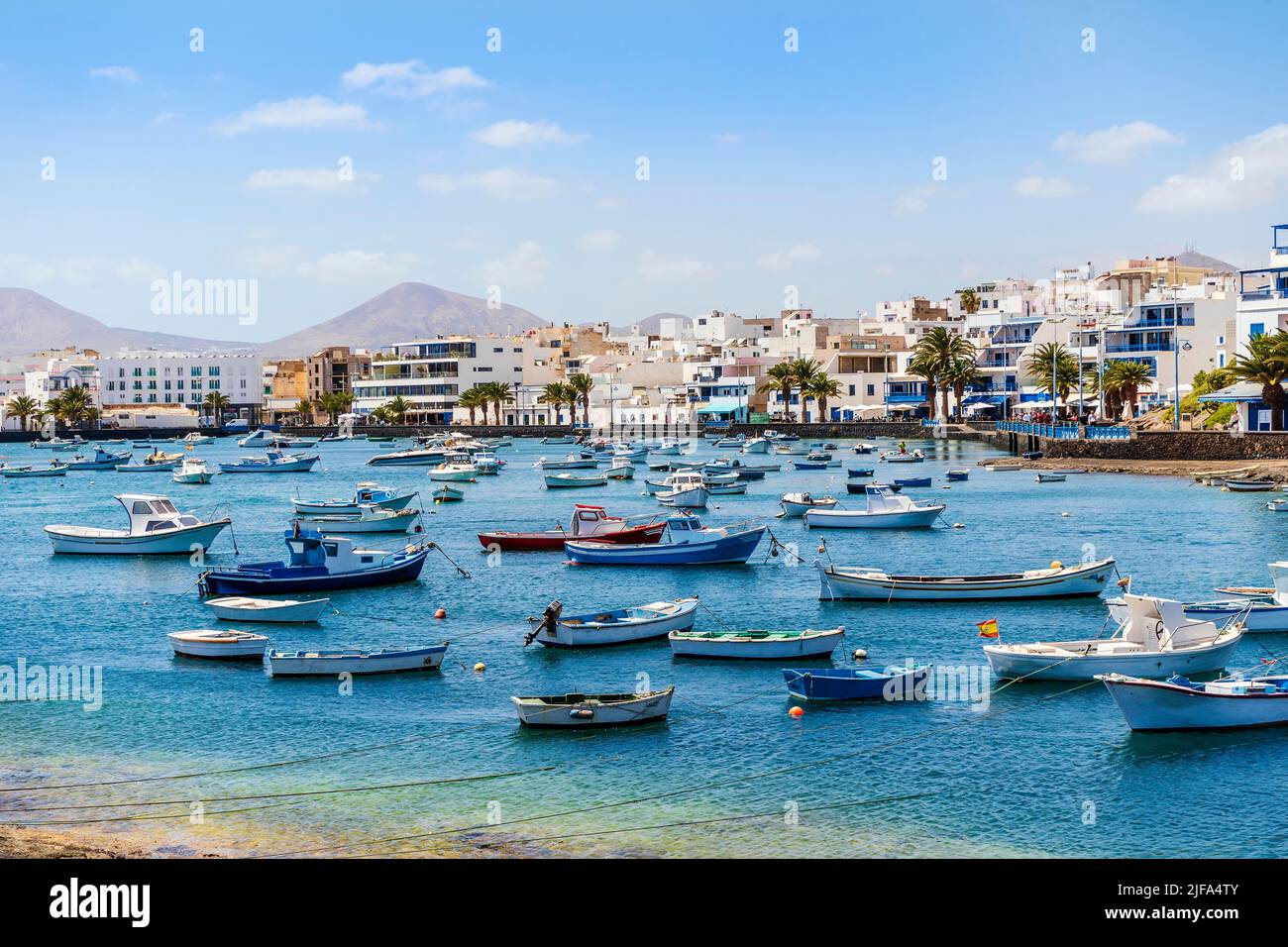 Beautiful seaside downtown of Arrecife with many boats floating on blue water, Lanzarote, Canary Islands, Spain Stock Photo