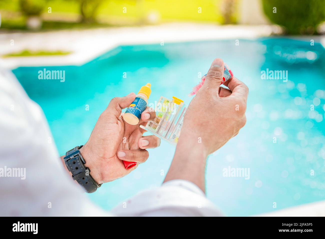 Pool Testing With Hand Tools Hand holding a pool ph and chlorine tester, Hand holding Water Test Kit ...