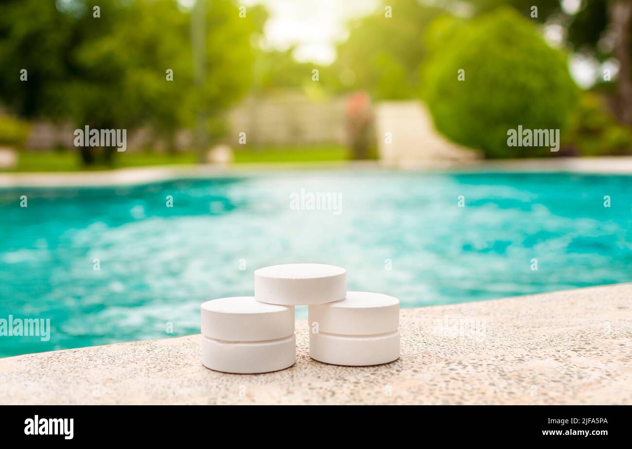 Closeup of chlorine tablets for swimming pool cleaning, chlorine tablets on the edge of a swimming pool, chlorine tablets for swimming pool Stock Photo