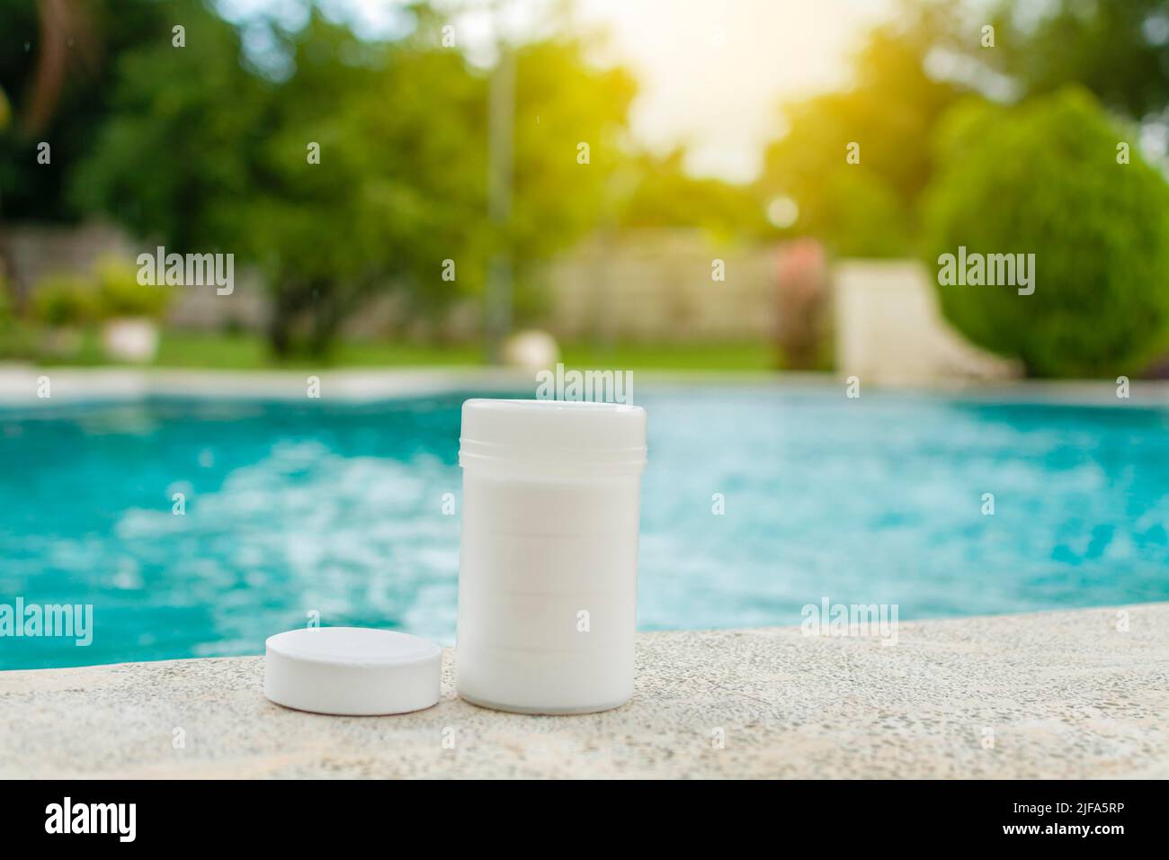 Chlorine tablets kit in the edge of a swimming pool, chlorine tablets