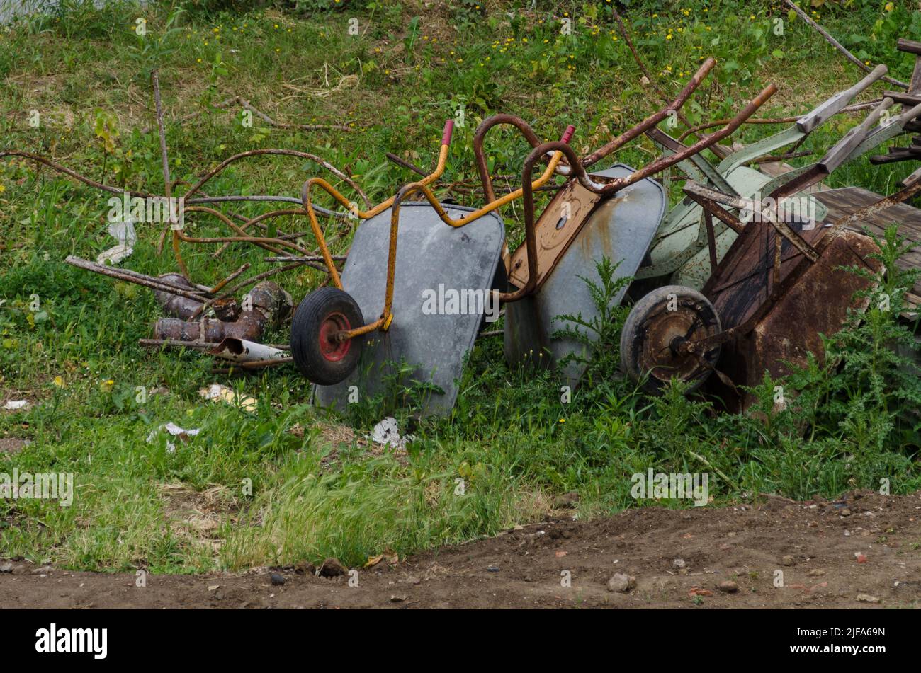 Unauthorized dumping of wheelbarrows and metal scrap Stock Photo