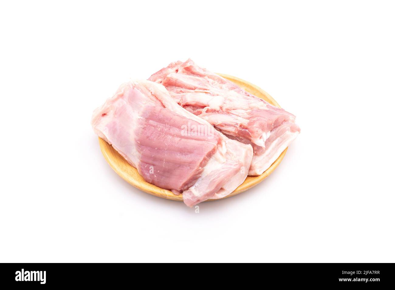 Close up raw streaky pork on wooden dish isolated on white background ...