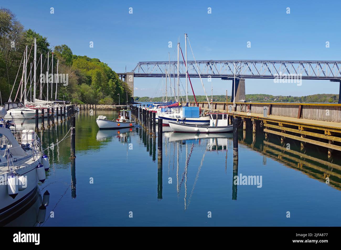 Leisure boats in a harbour basin, railway bridge over the Little Belt, Middelfart, Funen, Denmark Stock Photo