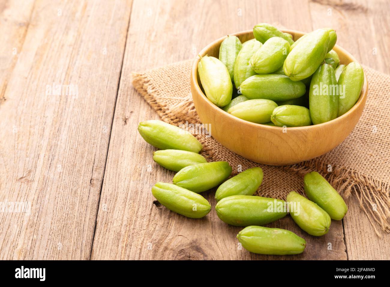 Close up bilimbi fruit or Averrhoa bilimbi on wooden table background. Food and healthcare concept Stock Photo