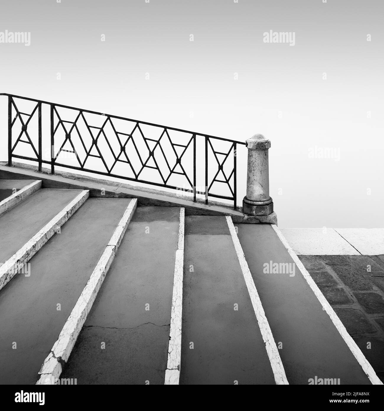 Black and white photograph of a bridge railing in the fog at the ...